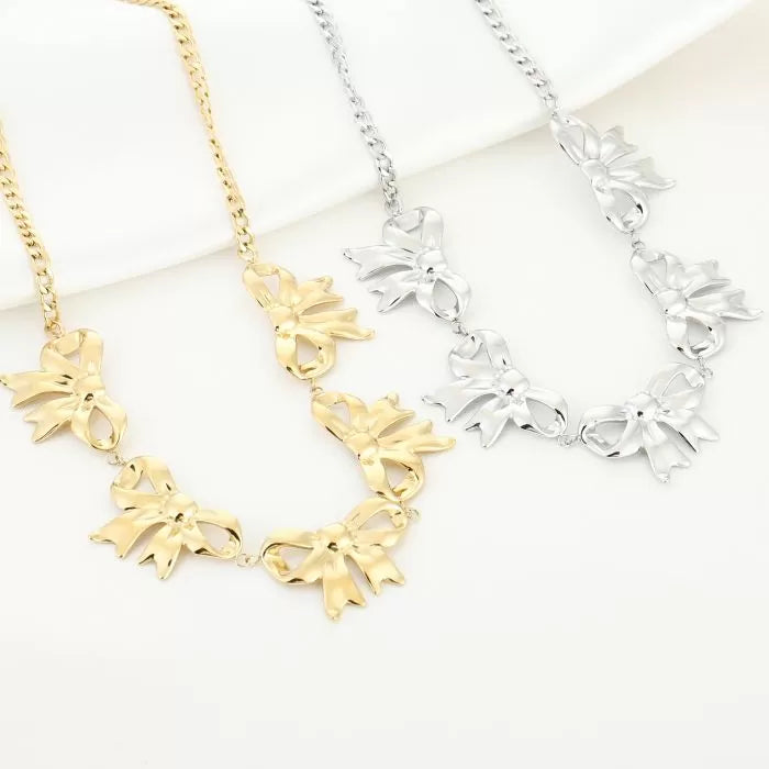 Golden Bow en Silver Bow kettingen naast elkaar – stainless steel sieraden collectie